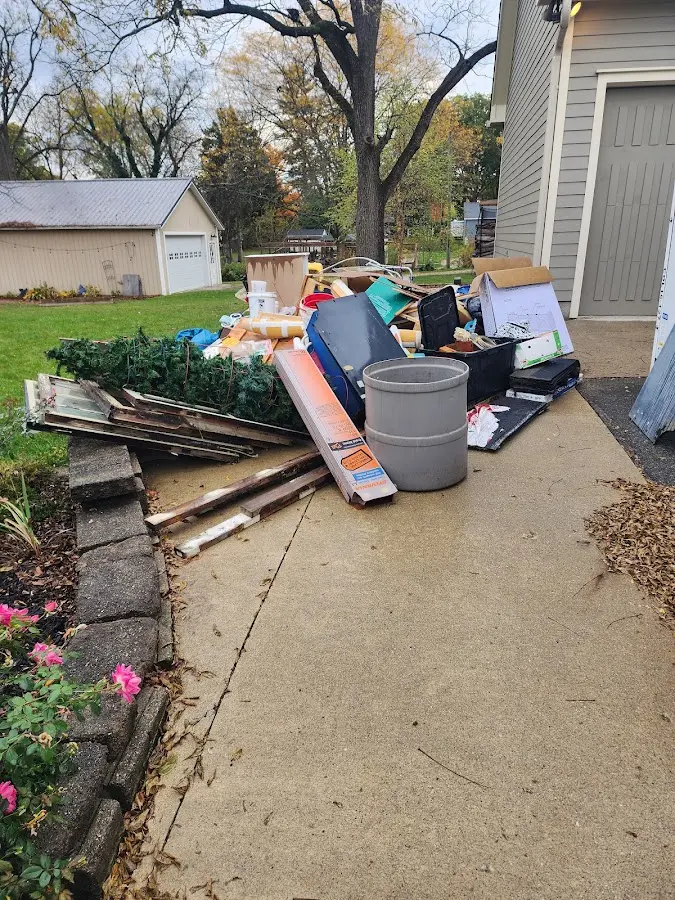 Dumpster being loaded with debris for Residential Dumpster Rental in Watertown